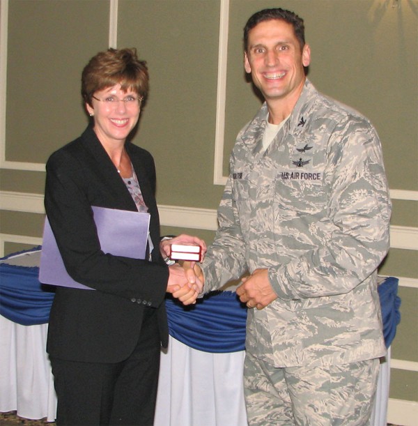 Kerry E. Kelley, director of command, control, communications, and computer systems and chief information officer, U.S. Strategic Command, receives a memento from Col. Donovan L. Routsis, USAF, chapter president, for speaking to the chapter in October.